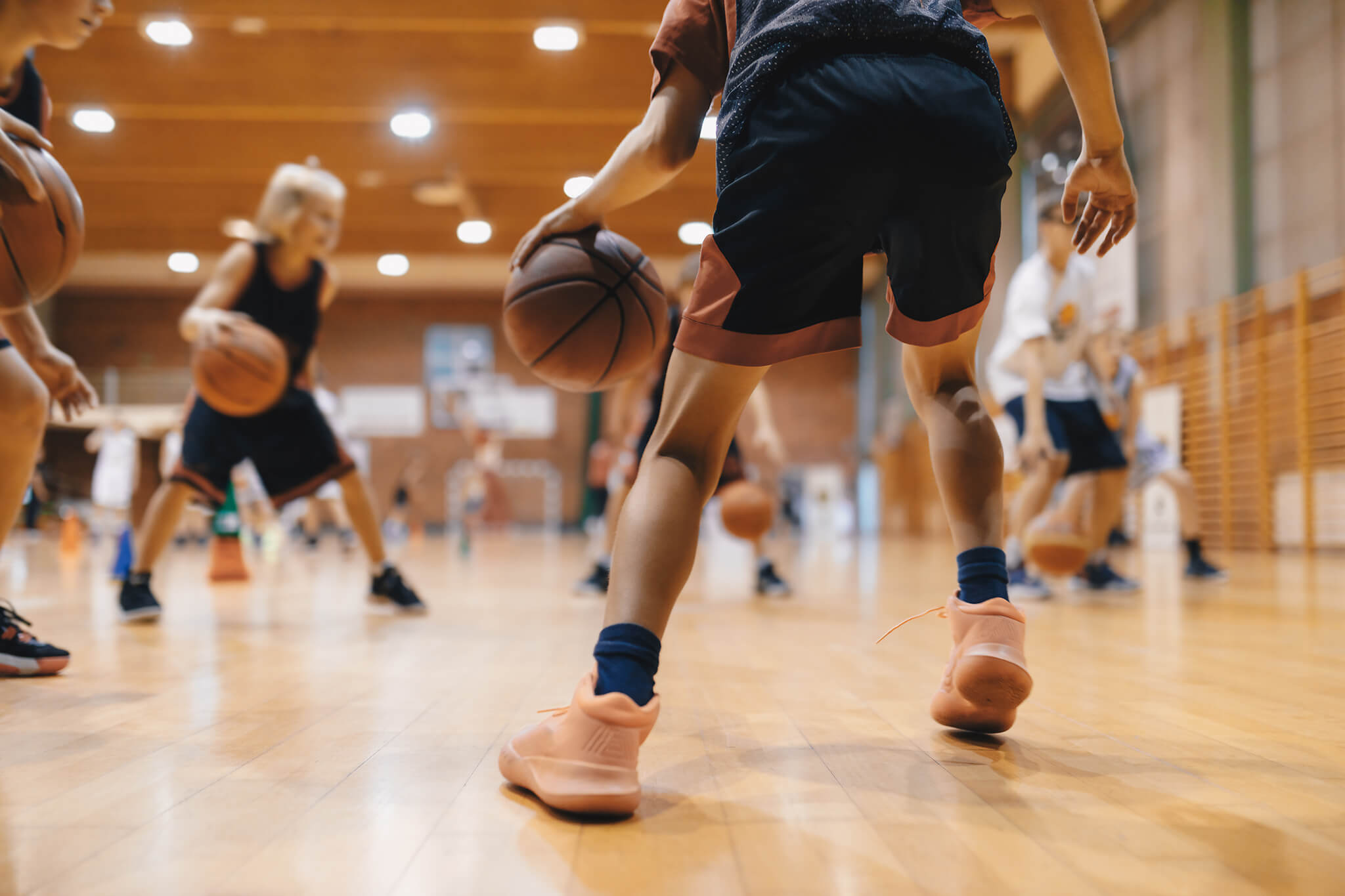 Students playing basketball in a gym